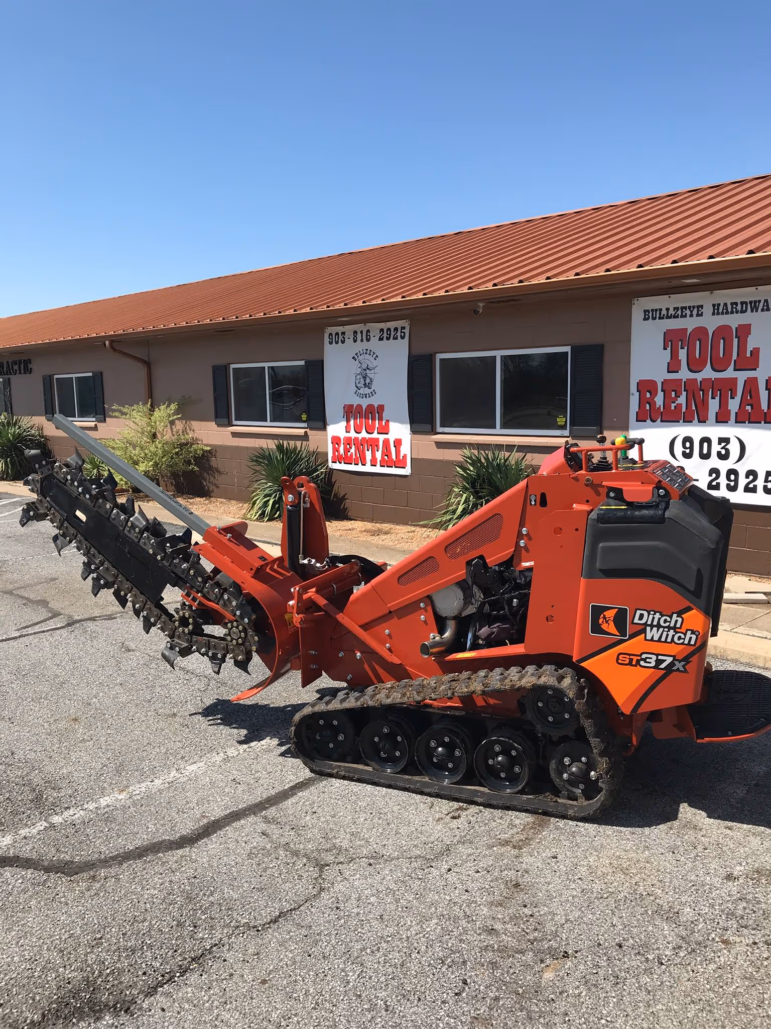 Mini skid steer with trencher attachment